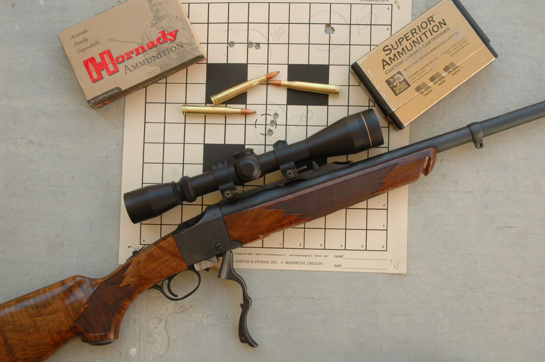 An interesting target from the most accurate Ruger No. One Boddington has owned, in .300 H&H. Center group, vertical stringing with hand-loaded 200-grain Sierra GameKing. Top left, horizontal stringing with Hornady 180-grain factory. Top right, a perfect group with handloaded 150-grain Sierra GameKing. All three are very acceptable for hunting accuracy, but you never know what might work just a bit better!