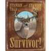 Tin Camp Sign With a Picture Of a Large Buck And The Saying Standing Tall & Standing Proud, I'm a Survivor On It. It Measures 12 1/2" X 16".